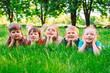 © davit85 - A group of children lying on the green grass in the Park. The interaction of the children.