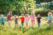 © davit85 - Large group of kids, friends boys and girls running in the park on sunny summer day in casual clothes .