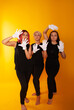 © Marina Chernivetskay - women in white gloves in the image of mimes actress play acting on a yellow background