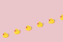 Creative Pattern Made With Yellow Rubber Duck  On Pastel Pink Background. Surreal Bathing Concept. Retro Style Aesthetic Idea With Copy Space.