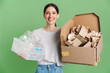 © Drobot Dean - Young brunette woman posing with plastic and paper waste