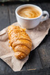 croissant and a cup of coffee fresh portion ready to eat meal snack on the table copy space food background rustic. top view