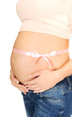 Wall Mural - Young pregnant female belly tied with pink ribbon