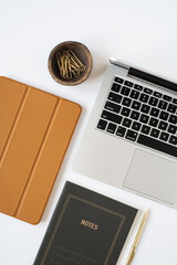 Wall Mural - Aesthetic home office desk workspace with laptop computer, notebook, tabled pad on white background. Flat lay, top view blog, website, social media concept.