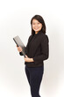 © Sino Images Studio - Beautiful Asian Woman Wearing black suit Holding laptop Isolated on white background