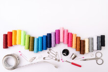 Colorful Threads And Sewing Accessories On A White Background. Sewing Background