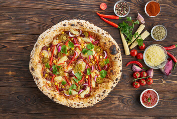 Wall Mural - Tradition homemade spicy mexican pizza with chili, beef, onion, jalapeno pepper and ingredients top view on wooden table. Cooking at home concept