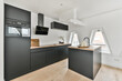 © ADDICTIVE STOCK - Modern kitchen with matte black furniture