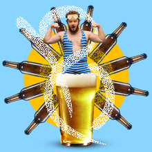 Contemporary Art Collage. Man In Swimsuit Standing In Glass With Foamed Cold Lager Beer Isolated On Blue Background. Beer Bottles Steering Wheel