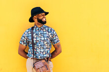 Trendy Black Man With Beard And Tattoos On Yellow Background