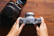 Crop Photographer With Retro Photo Camera On Table