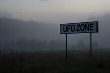 Signpost With Text Ufo Zone On The Background Of The Evening Foggy Forest.