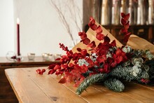 Stylish Christmas Bouquet Placed On Wooden Table