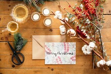 Festive Christmas Composition With Colorful Postcard Against Wooden Background