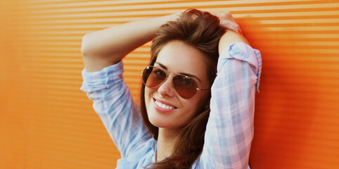 Wall Mural - Summer portrait of attractive young brunette smiling woman in the city