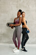© Drazen - Full length of young happy athletic women against the wall.
