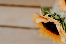 Closeup Shot Of A Sunflower Over A Wooden Surface