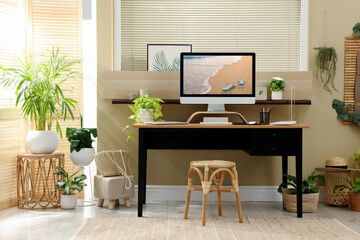 Light room interior with comfortable workplace near window