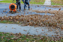 Worker Operating Heavy Duty Leaf Blower In Removing Fallen Leaves Of Autumn