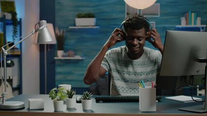 Poster - Business worker doing remote online work on computer while listening to music with headphones. Corporate employee having fun and dancing while working with technology for project