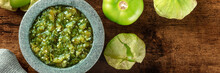 Tomatillos, Green Tomatoes, And Salsa Verde, Green Sauce, Panorama With A Molcajete, Traditional Mexican Mortar, Overhead Flat Lay Shot With Copy Space