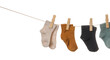 © Pixel-Shot - Different baby socks hanging on rope against white background