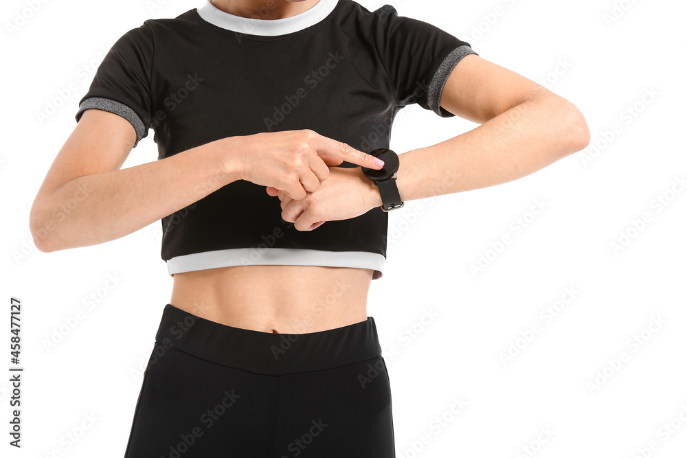 Sporty young woman checking pulse on white background