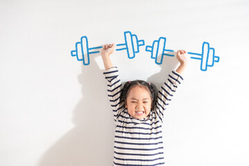 funny positive strong asian little toddler kid girl lifting weight against the textured white backgr