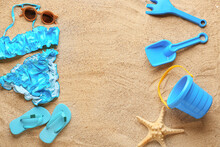 Set Of Beach Accessories For Children And Stylish Swimsuit On Sand
