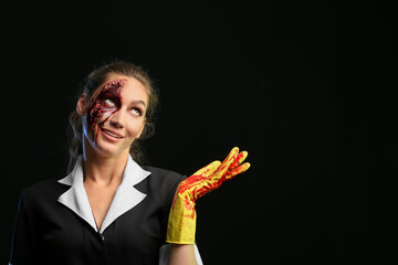 Sticker - Woman dressed for Halloween as chambermaid showing something on dark background