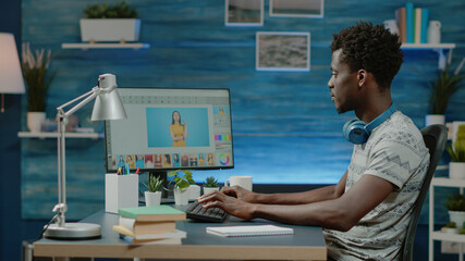 Poster - African american photographer retouching pictures on computer screen. Black graphic designer doing editing work on photos for photography production. Image editor designing photograph