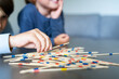 © Anna - Cheerful children playing mikado in the living room at home, close up. Kids spending time together. Family weekend. Colored plastic sticks game. Activity ideas, home games , indoor entertainment.