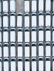 aerial view of a manufacturer’s stockpile of new white vans parked together