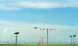 © Artinun - Commercial airplane flying above approach light at the airport. Approach light system concept. Airport runway approach lights. ALS of the airport. Fence for security. Plane take off from the airport.