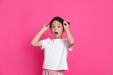 Poster - Cute girl in pajamas with sleep mask on pink background