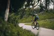 © Tymoshchuk - Muscular man in sport clothes and helmet cycling outdoors