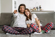 © Drobot Dean - Young multiracial couple watching tv while resting together on sofa