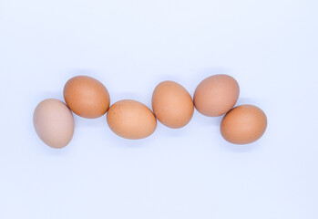 Wall Mural - Closeup of the chicken eggs isolated on white background.