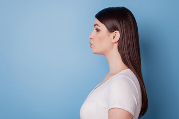 Wall Mural - Profile portrait of romantic cute lady look empty space send air kiss on blue background