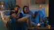 © Framestock - Diverse couple watching comedy film in evening
