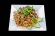 vietnamese cuisine, wok noodles in korean style, on a black isolated background, top