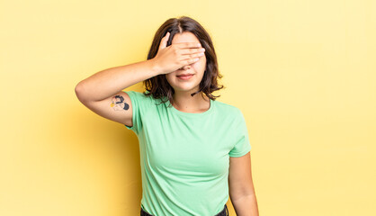 Wall Mural - young pretty girl covering eyes with one hand feeling scared or anxious, wondering or blindly waiting for a surprise