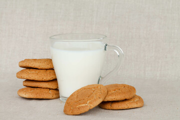 oatmeal cookies with a glass of milk on a linen background, text space