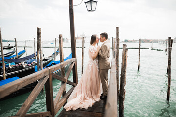 Wall Mural - Wedding couple on the nature is hugging each other. Beautiful model girl in white dress. Man in suit.Venice, Italy