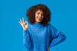 Count on me, everything ok. Cheerful and assertive african-american girlfriend with afro haircut have all under control, showing alright okay gesture and wink, smiling positive reply, blue background