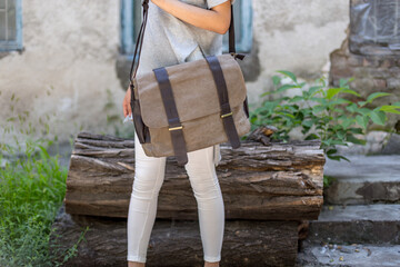 woman with a gray canvas messenger bag