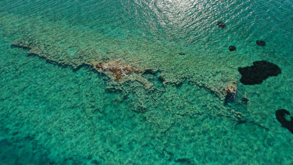 Aerial drone photo of prehistoric settlement of Pavlopetri a sunken city and archaeological site just below surface near popular Pounta beach and Elafonisos island, Peloponnese, Greece