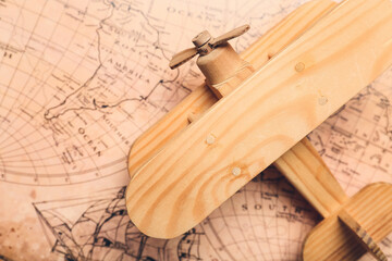 Sticker - Wooden airplane on vintage world map