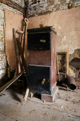 Wall Mural - Old fuel boiler in the interior of a crumbling house (wooden house).