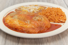 Chili Relleno Served On A Plate With Rice, And Beans For A Very Hearty Mexican Meal